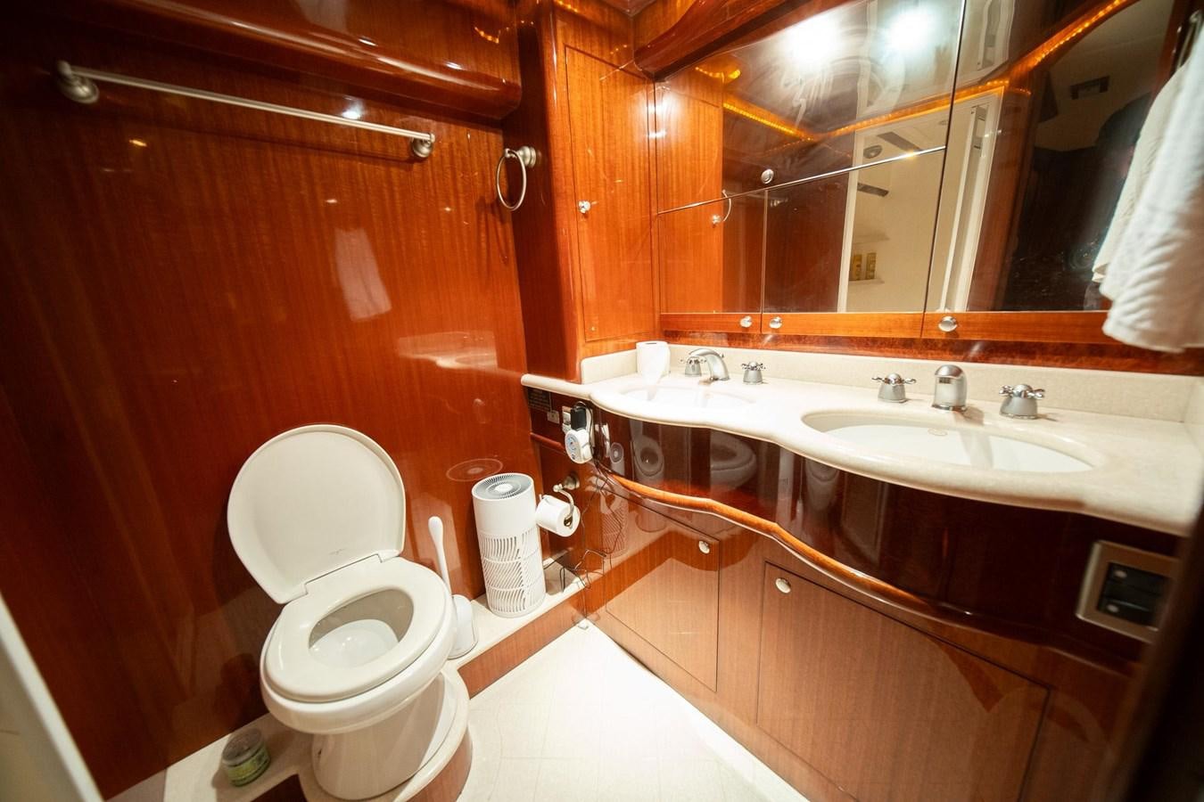 a bathroom with a toilet sink and a mirror aboard PRETTY PENNY Yacht for Sale