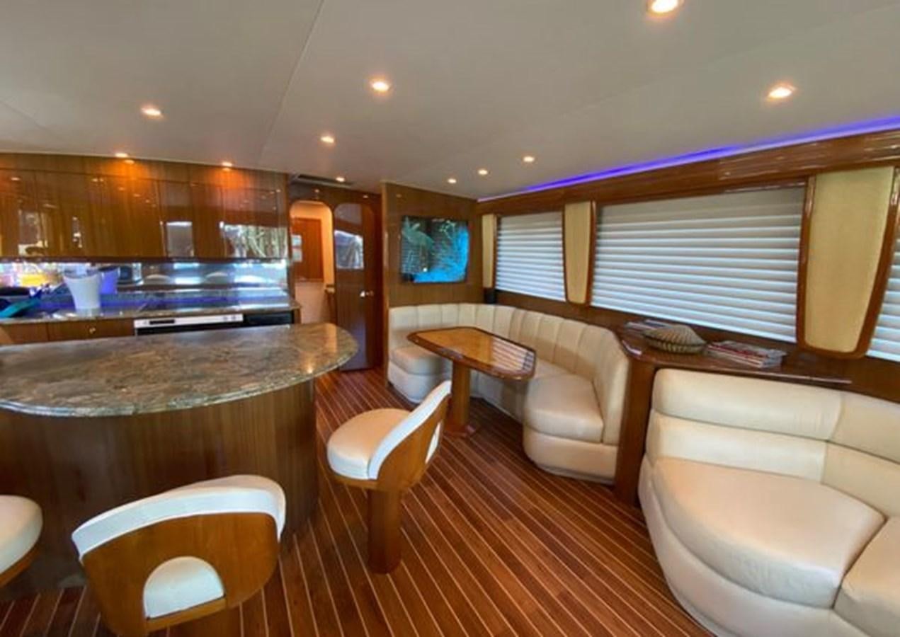 a living room with a bar and a table aboard LIKE WHAT U SEA Yacht for Sale
