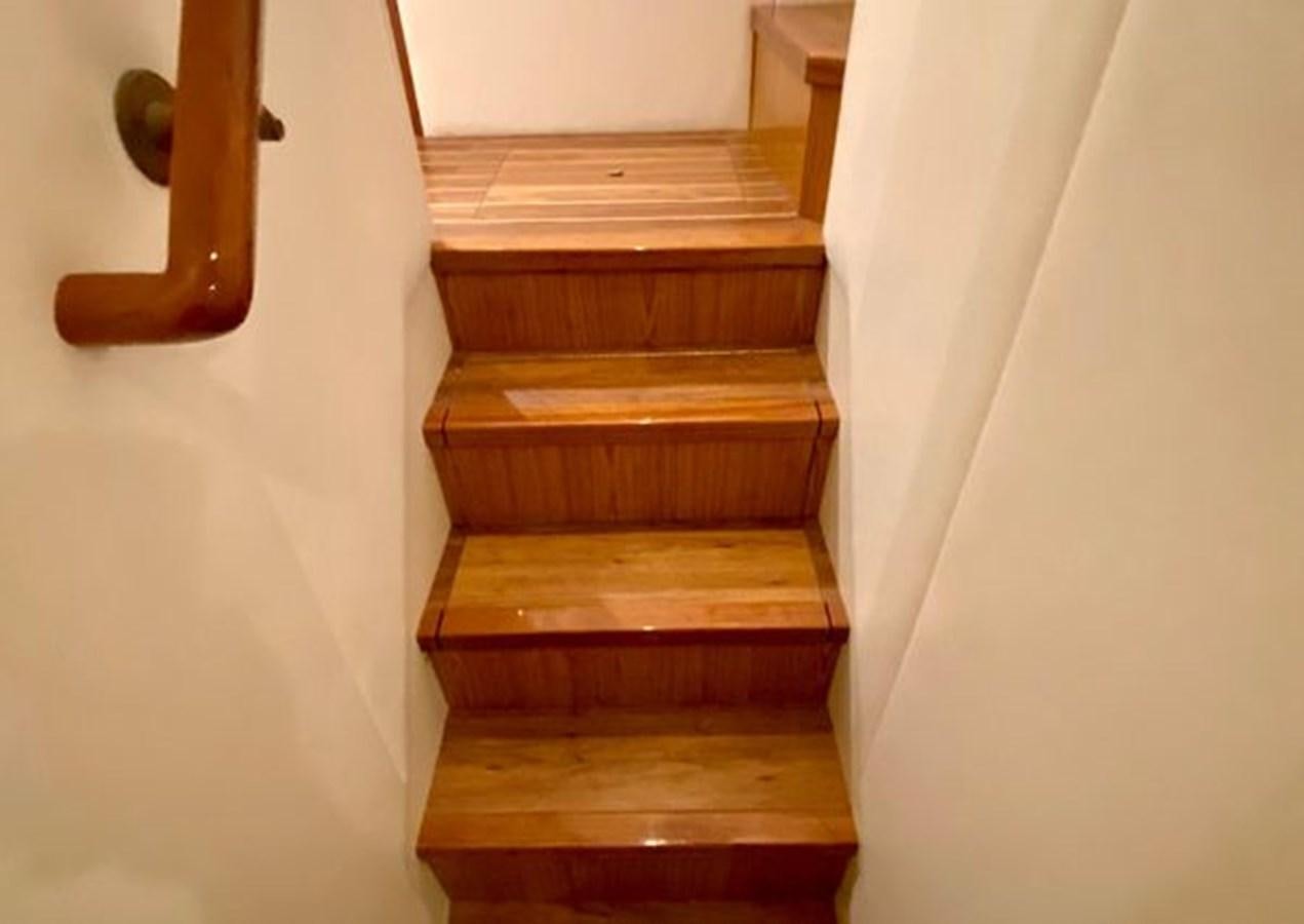 a staircase with a white wall aboard LIKE WHAT U SEA Yacht for Sale