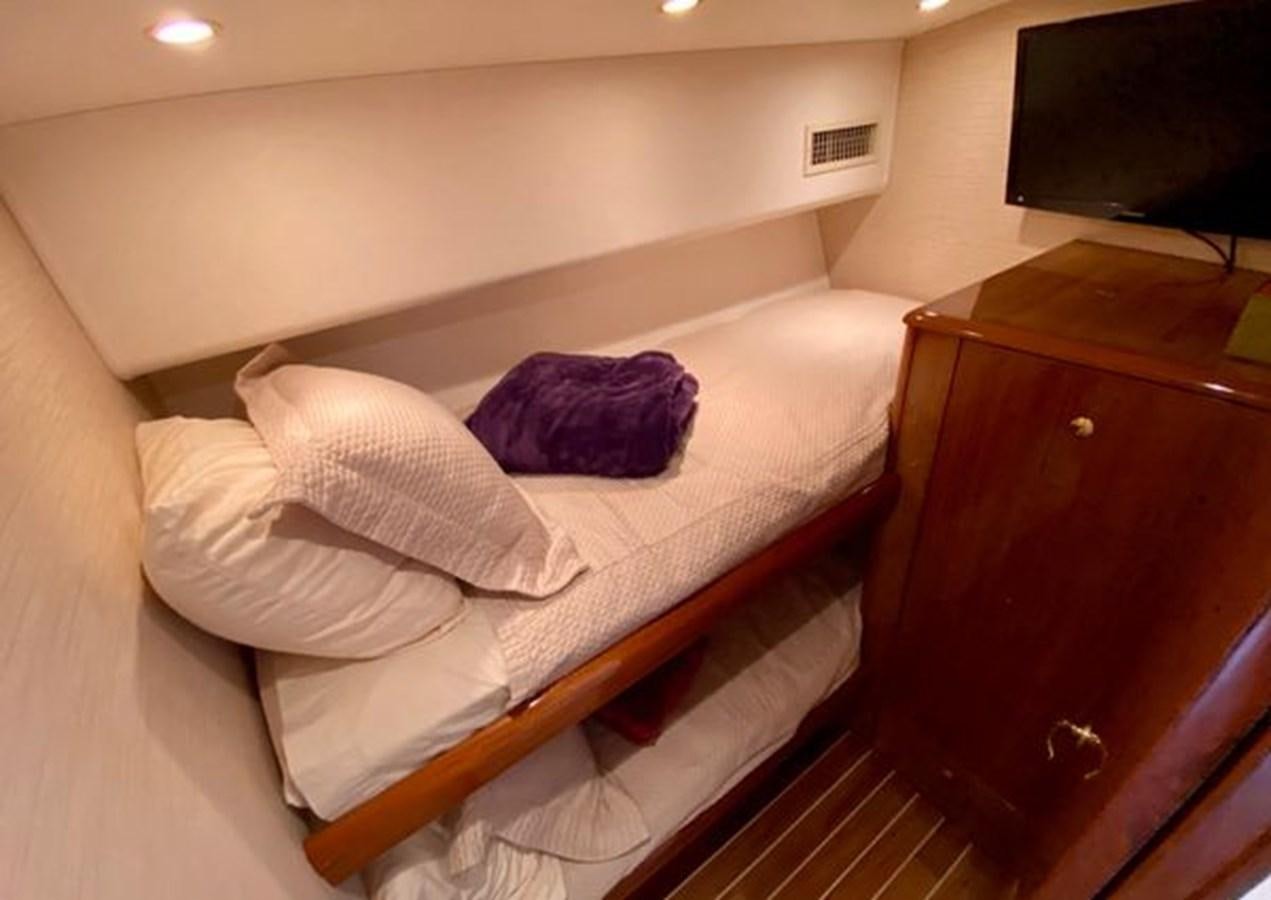 a bed with a blue pillow aboard LIKE WHAT U SEA Yacht for Sale