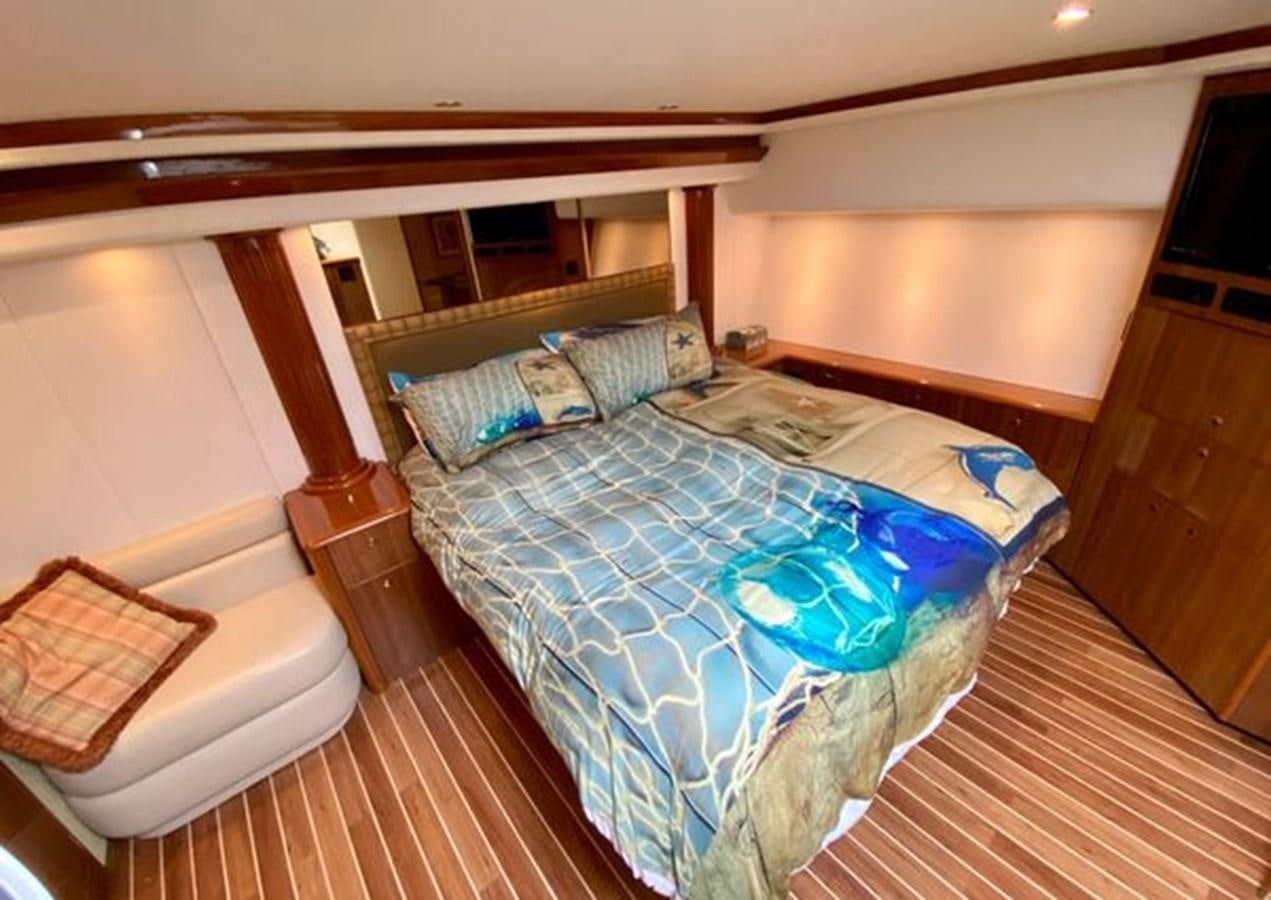 a bed with a blue sheet aboard LIKE WHAT U SEA Yacht for Sale