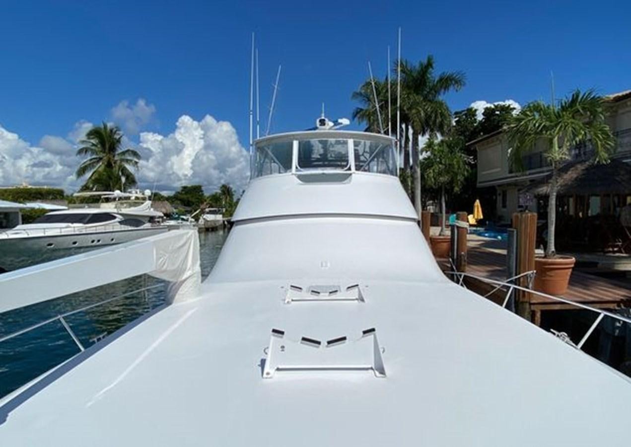 a white yacht in a tropical setting aboard LIKE WHAT U SEA Yacht for Sale