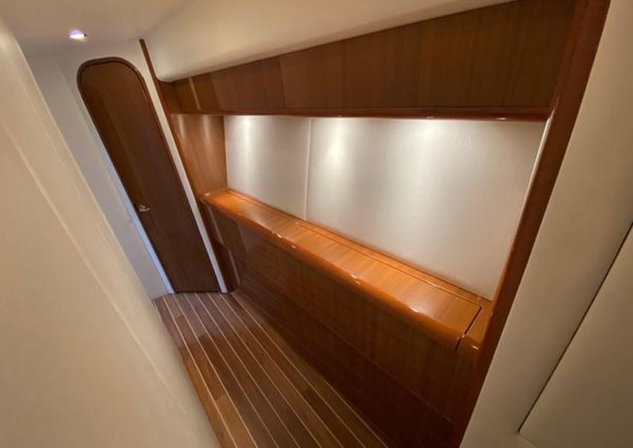 a wooden cabinet with a white door aboard LIKE WHAT U SEA Yacht for Sale