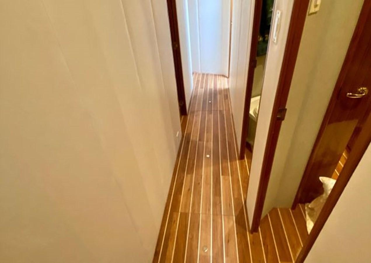 a hallway with a wood door aboard LIKE WHAT U SEA Yacht for Sale