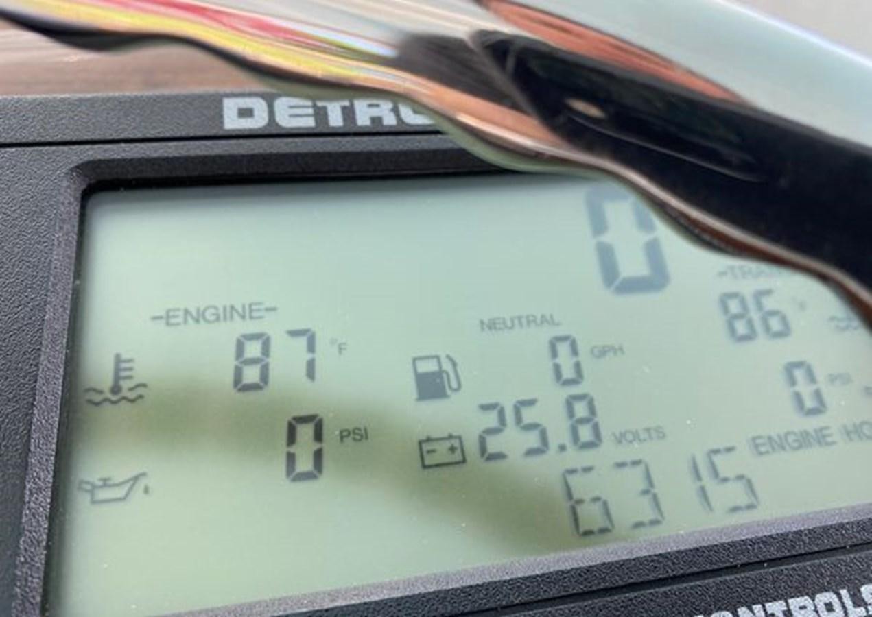 a digital clock on a table aboard LIKE WHAT U SEA Yacht for Sale