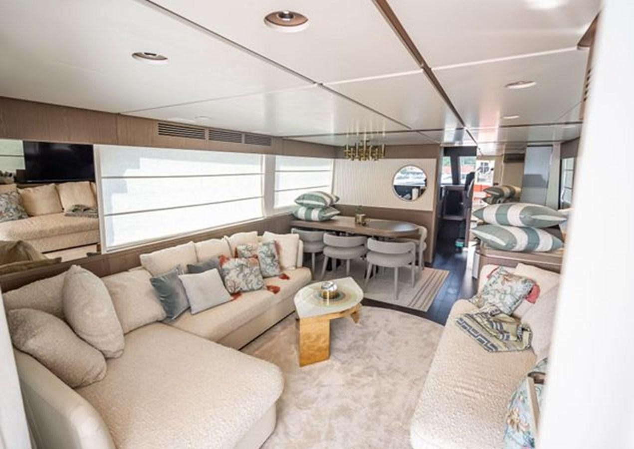 a living room with a couch and a table aboard AZIMUT MAGELLANO 30/15 Yacht for Sale