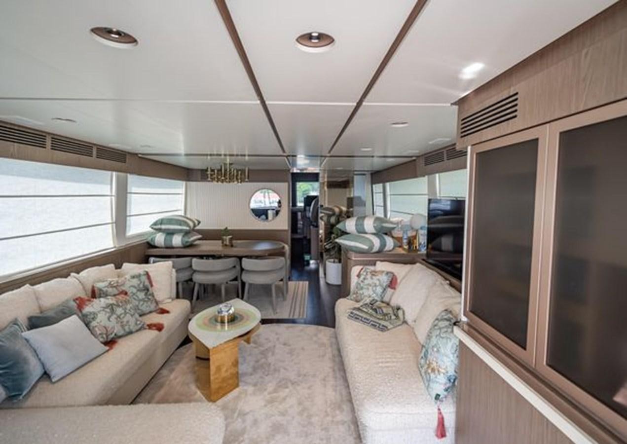 a living room with a couch and a table aboard AZIMUT MAGELLANO 30/15 Yacht for Sale