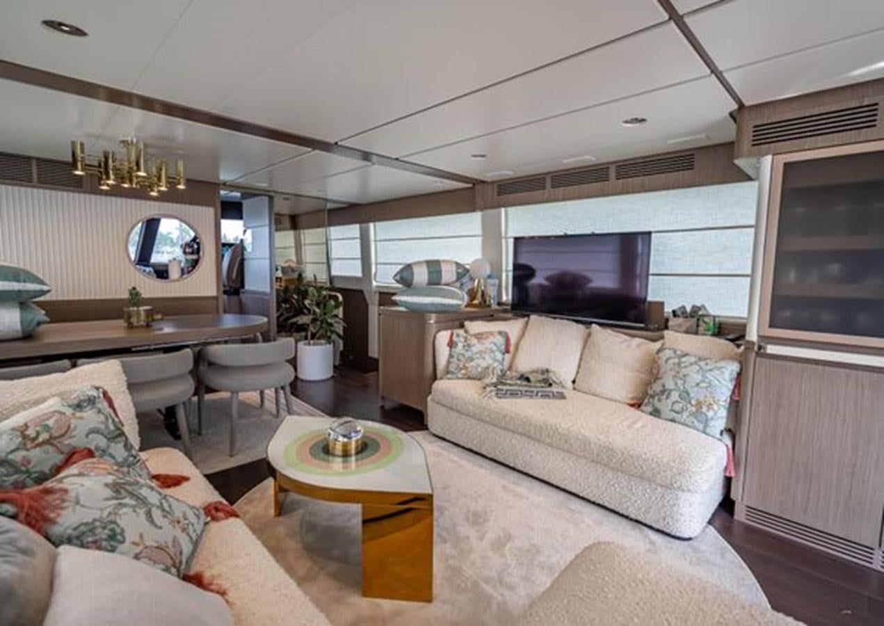 a living room with a couch and a table aboard AZIMUT MAGELLANO 30/15 Yacht for Sale