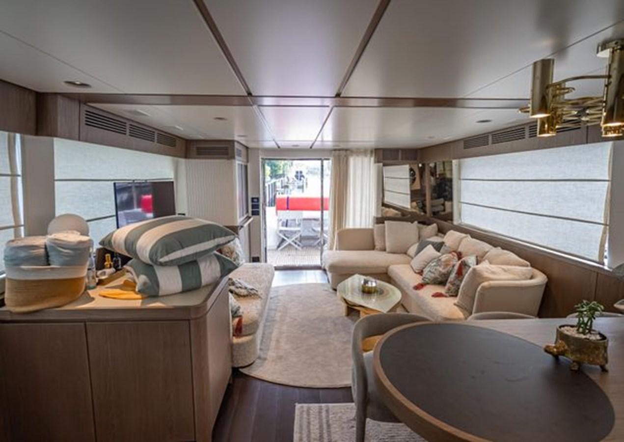 a living room with a couch and a table aboard AZIMUT MAGELLANO 30/15 Yacht for Sale