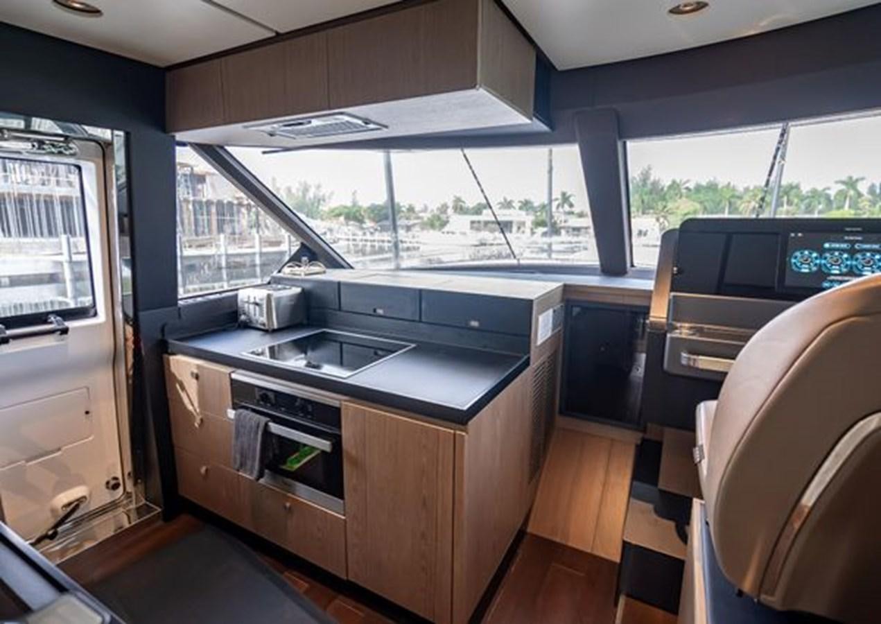 a kitchen with a large window aboard AZIMUT MAGELLANO 30/15 Yacht for Sale