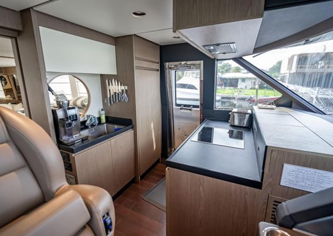 a kitchen with a large window aboard AZIMUT MAGELLANO 30/15 Yacht for Sale
