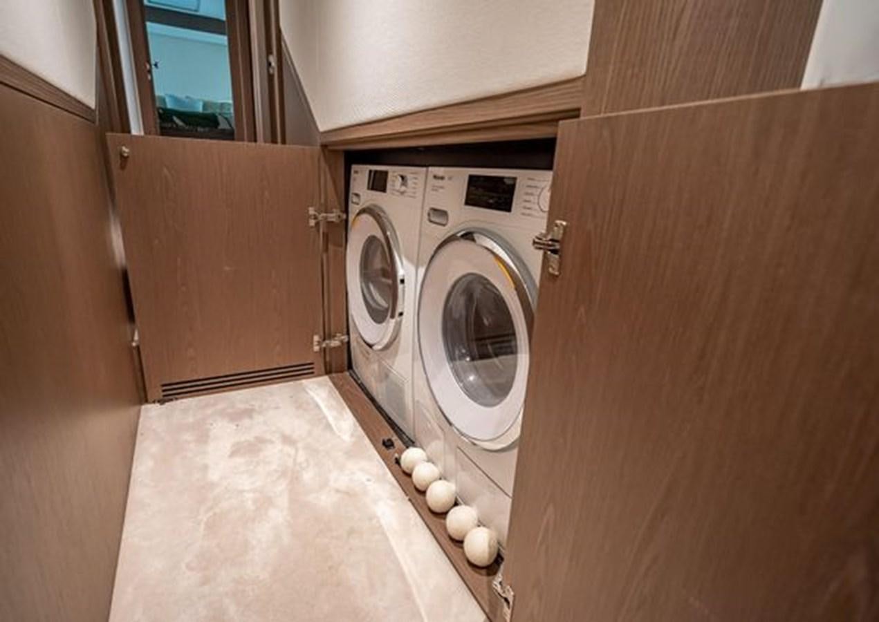 a washing machine in a room aboard AZIMUT MAGELLANO 30/15 Yacht for Sale