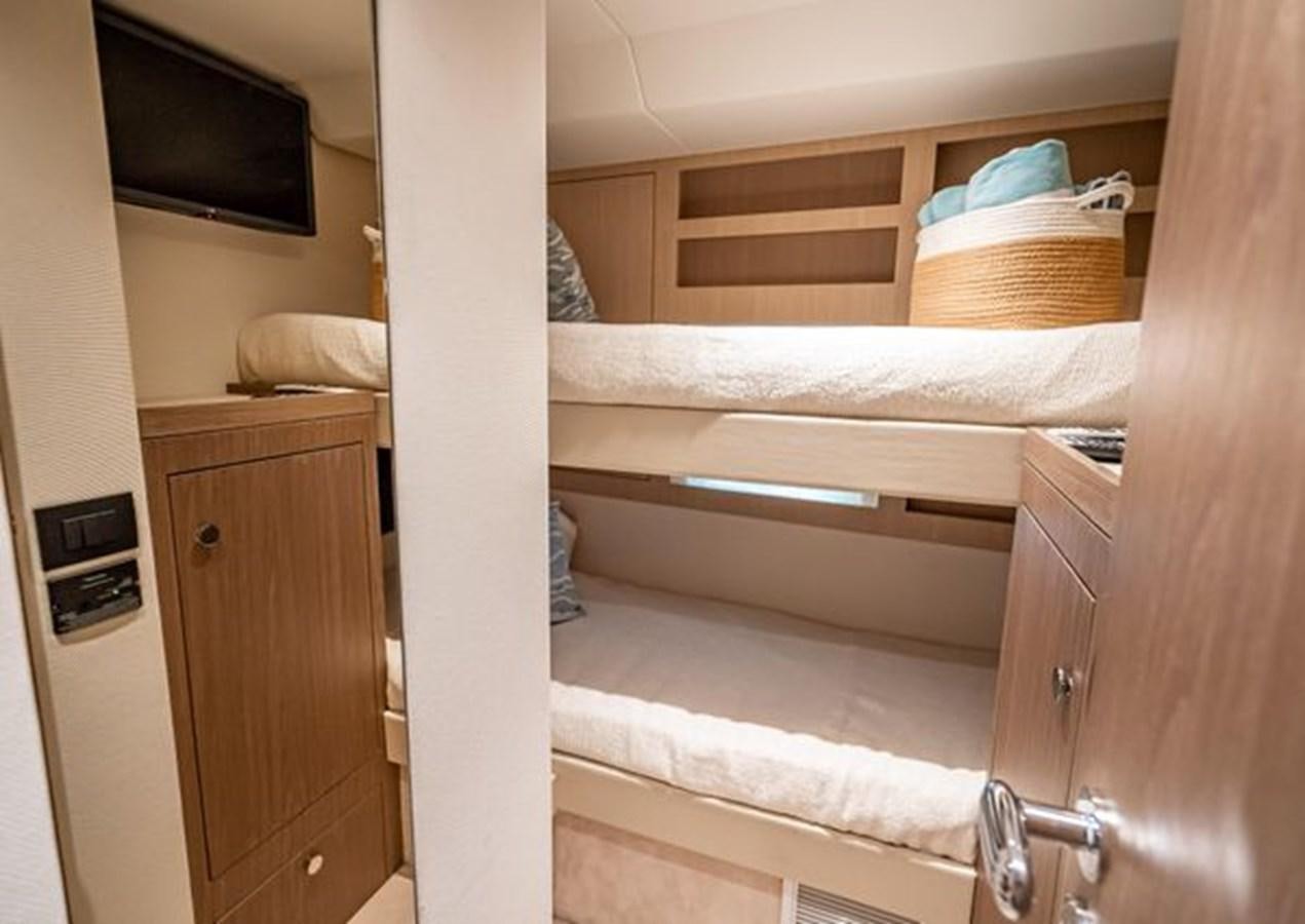 a bunk bed with a television on the wall aboard AZIMUT MAGELLANO 30/15 Yacht for Sale