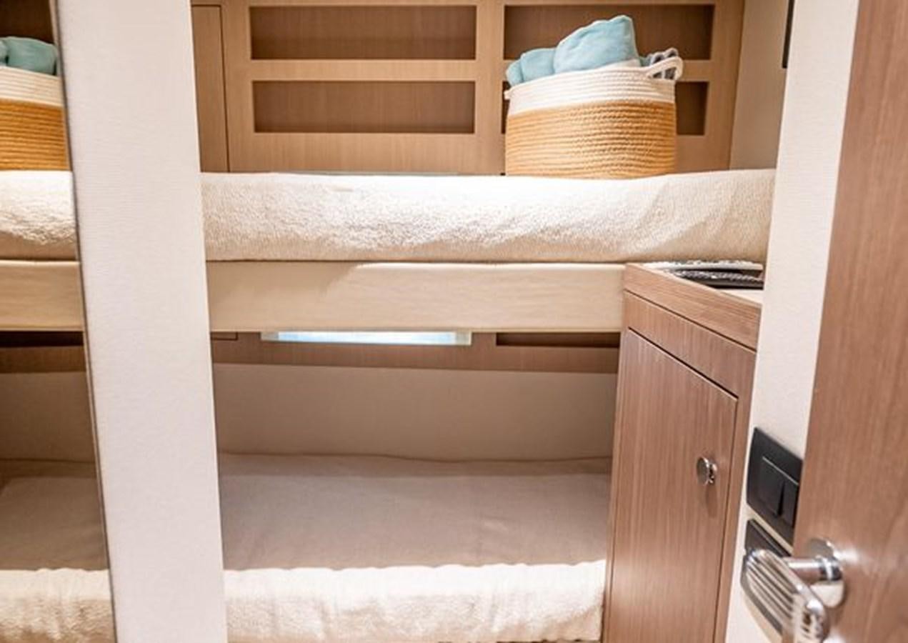 a white bed with a wooden frame aboard AZIMUT MAGELLANO 30/15 Yacht for Sale