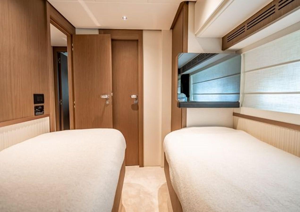 a room with a bed and a television aboard AZIMUT MAGELLANO 30/15 Yacht for Sale