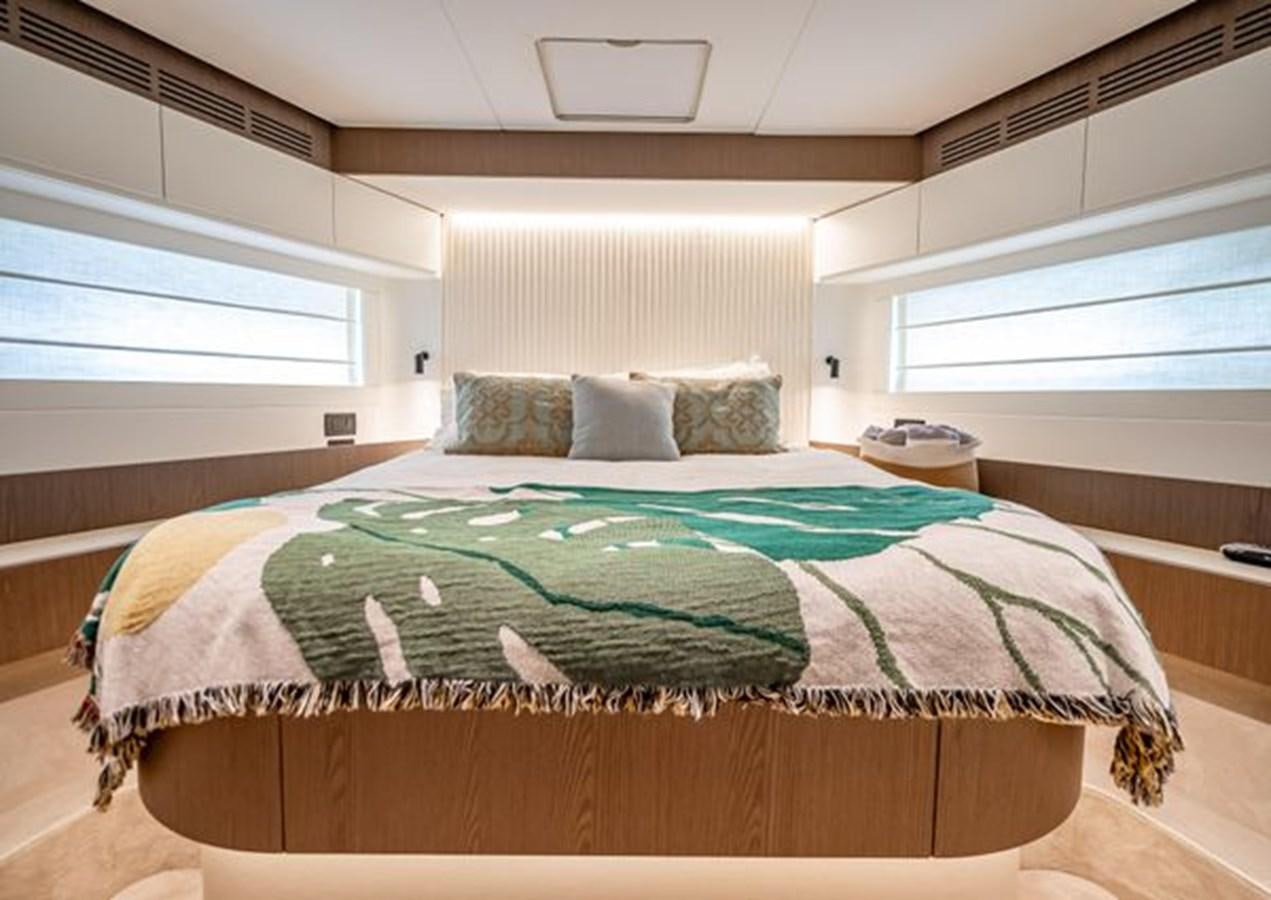 a bed with a green blanket aboard AZIMUT MAGELLANO 30/15 Yacht for Sale