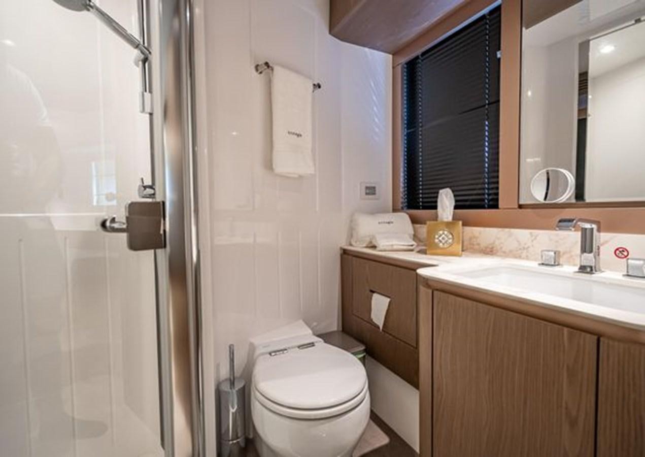 a bathroom with a toilet sink and a mirror aboard AZIMUT MAGELLANO 30/15 Yacht for Sale