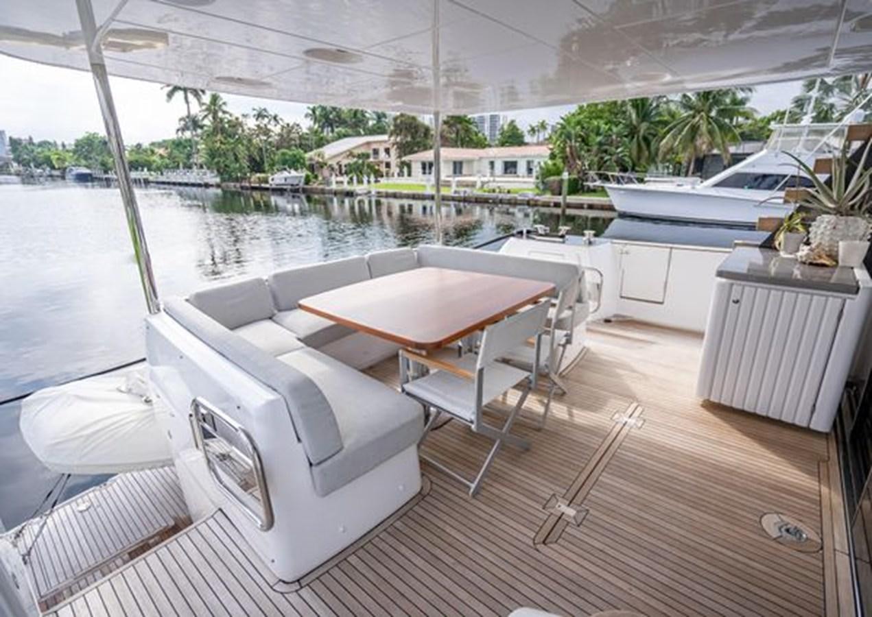 a room with a table chairs and a large window aboard AZIMUT MAGELLANO 30/15 Yacht for Sale