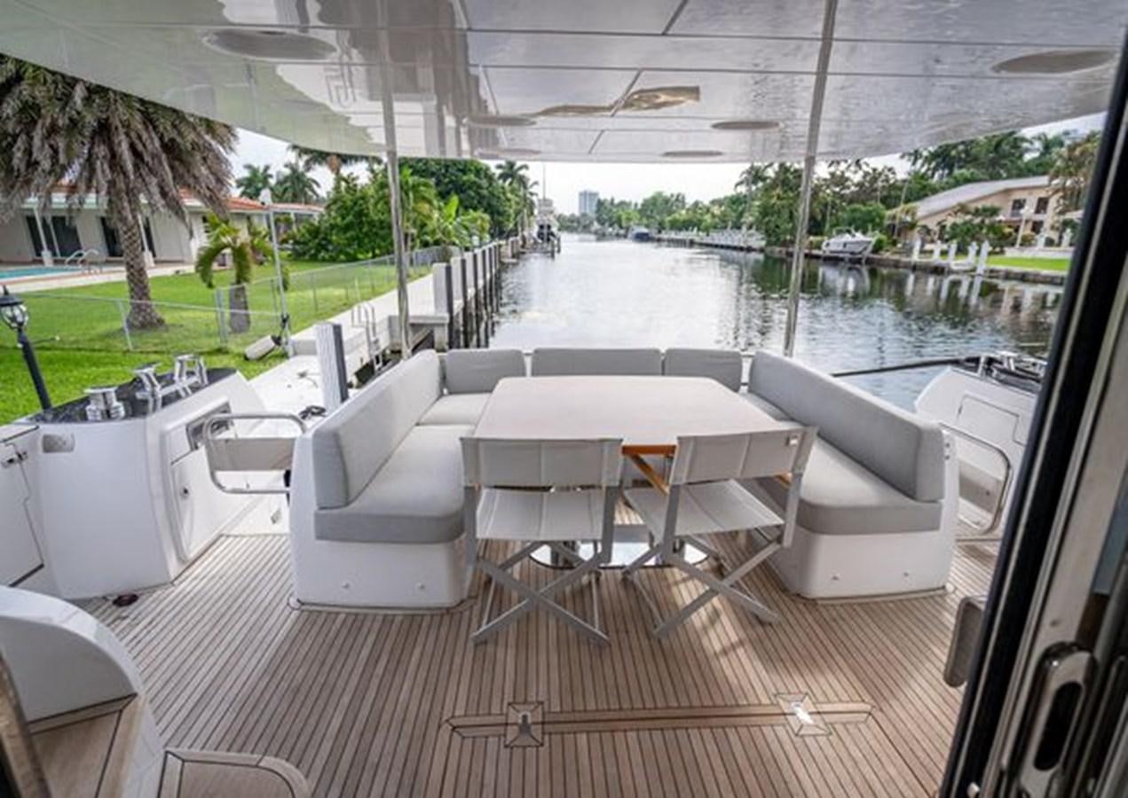 a group of white tables and chairs on a deck aboard AZIMUT MAGELLANO 30/15 Yacht for Sale
