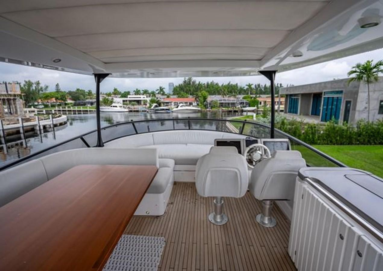 a room with a table chairs and a large pool aboard AZIMUT MAGELLANO 30/15 Yacht for Sale
