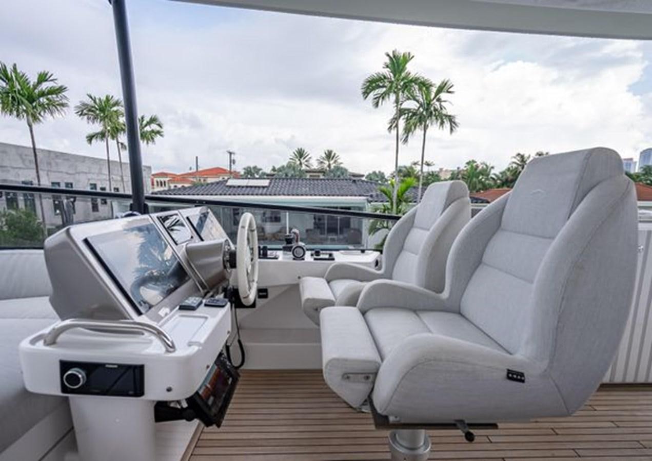a white couch on a deck aboard AZIMUT MAGELLANO 30/15 Yacht for Sale