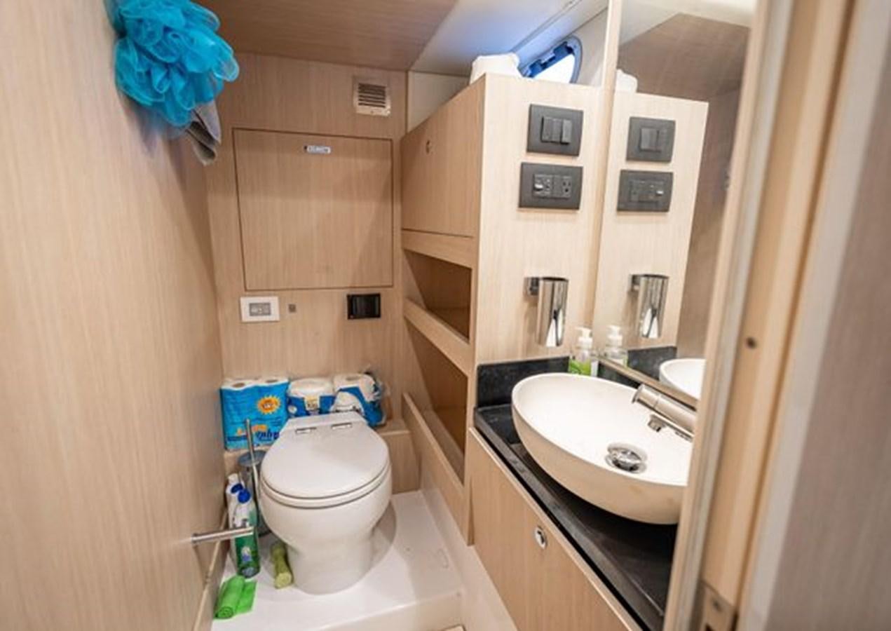 a bathroom with a sink toilet and a mirror aboard AZIMUT MAGELLANO 30/15 Yacht for Sale