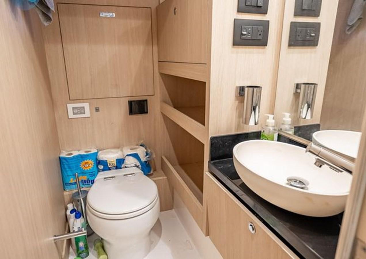 a bathroom with a sink toilet and a mirror aboard AZIMUT MAGELLANO 30/15 Yacht for Sale