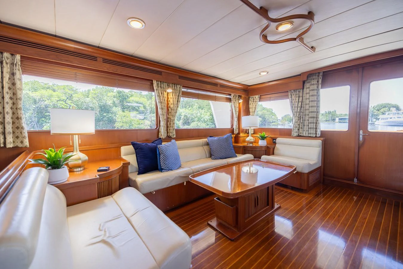 a room with a couch and a table and a lamp aboard THE GARLIC Yacht for Sale