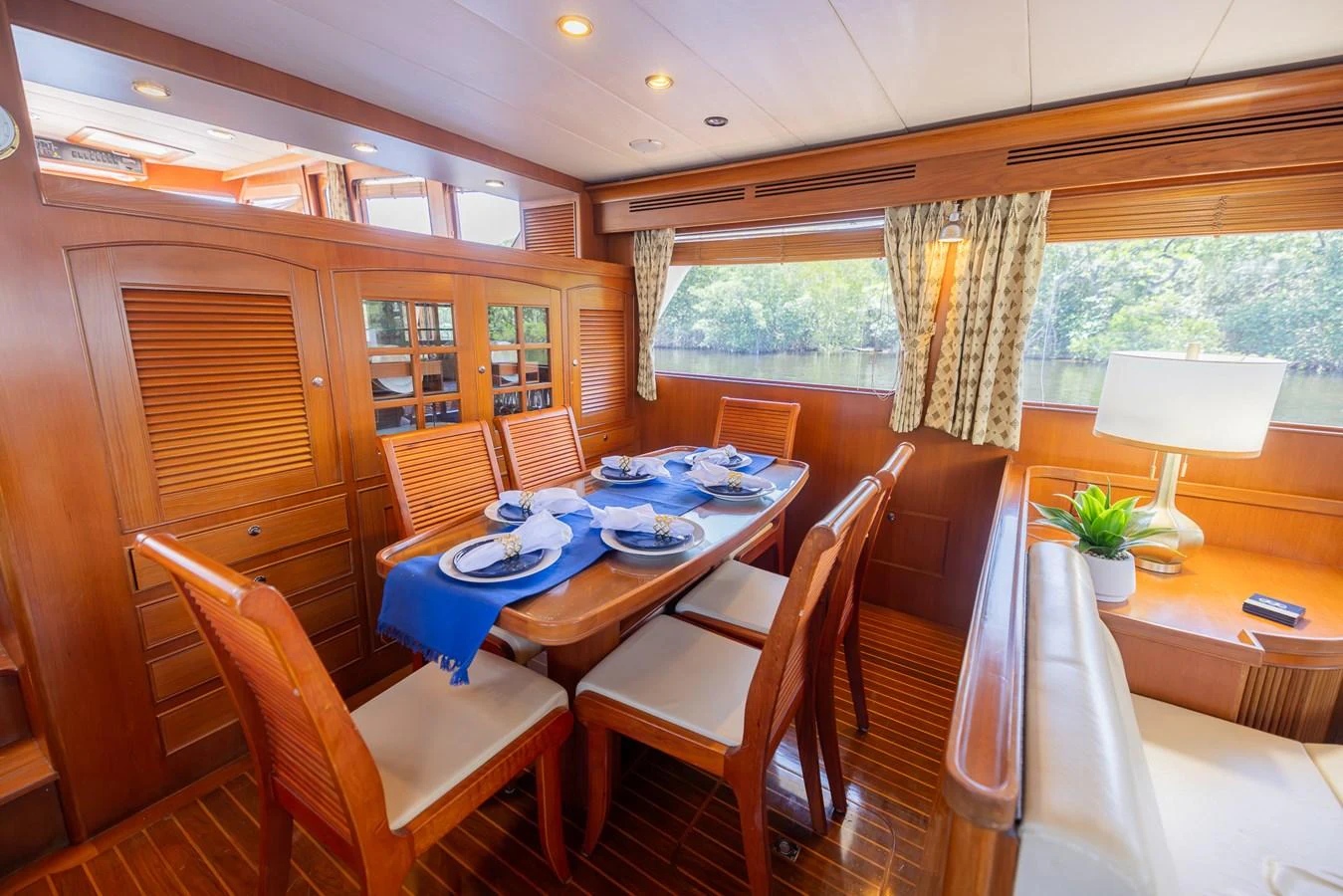 a dining table and chairs in a room with a window aboard THE GARLIC Yacht for Sale
