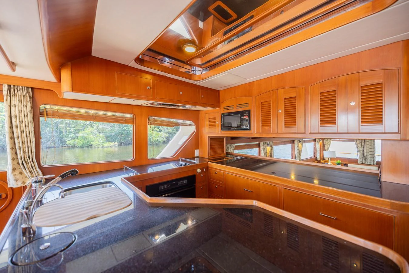 a kitchen with wooden cabinets aboard THE GARLIC Yacht for Sale