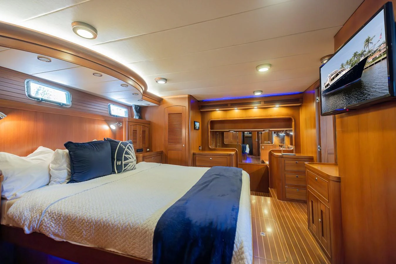 a bedroom with a bed and a television aboard THE GARLIC Yacht for Sale