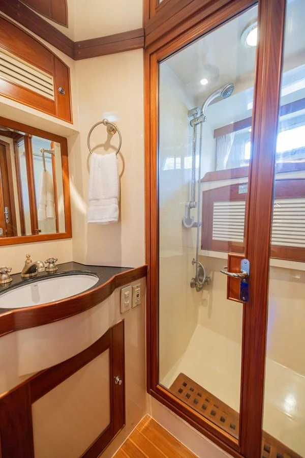 a bathroom with a glass shower door aboard THE GARLIC Yacht for Sale