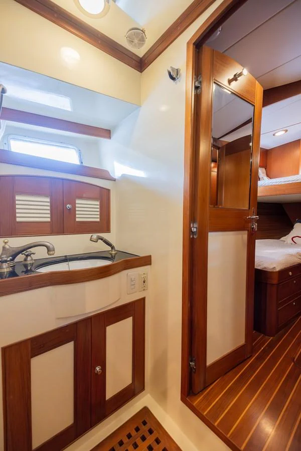 a bathroom with a sink and a mirror aboard THE GARLIC Yacht for Sale