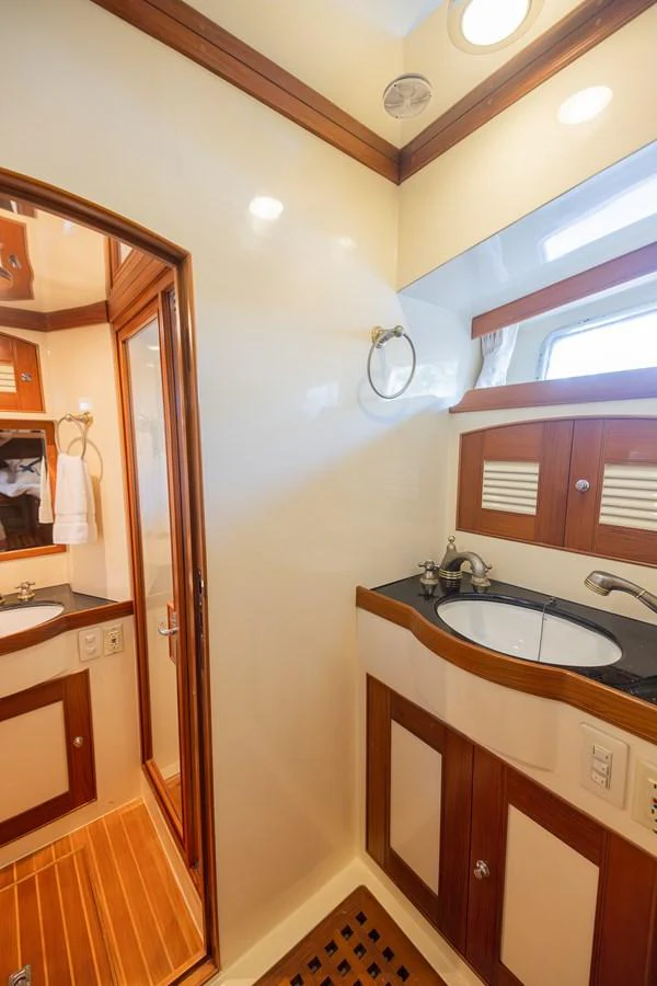 a bathroom with a sink and a mirror aboard THE GARLIC Yacht for Sale