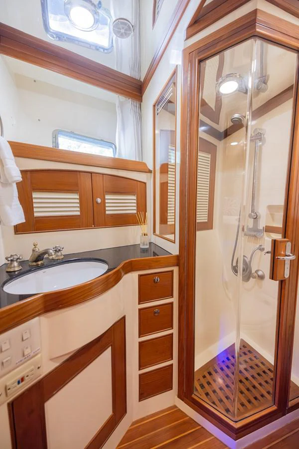 a bathroom with a sink and a shower unit aboard THE GARLIC Yacht for Sale