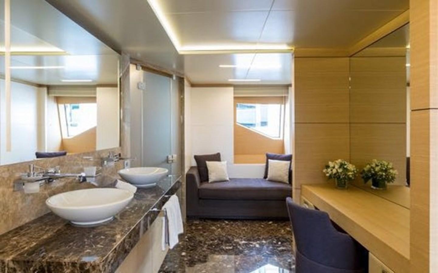 a modern bathroom with a large mirror aboard BENETTI 132 Yacht for Sale