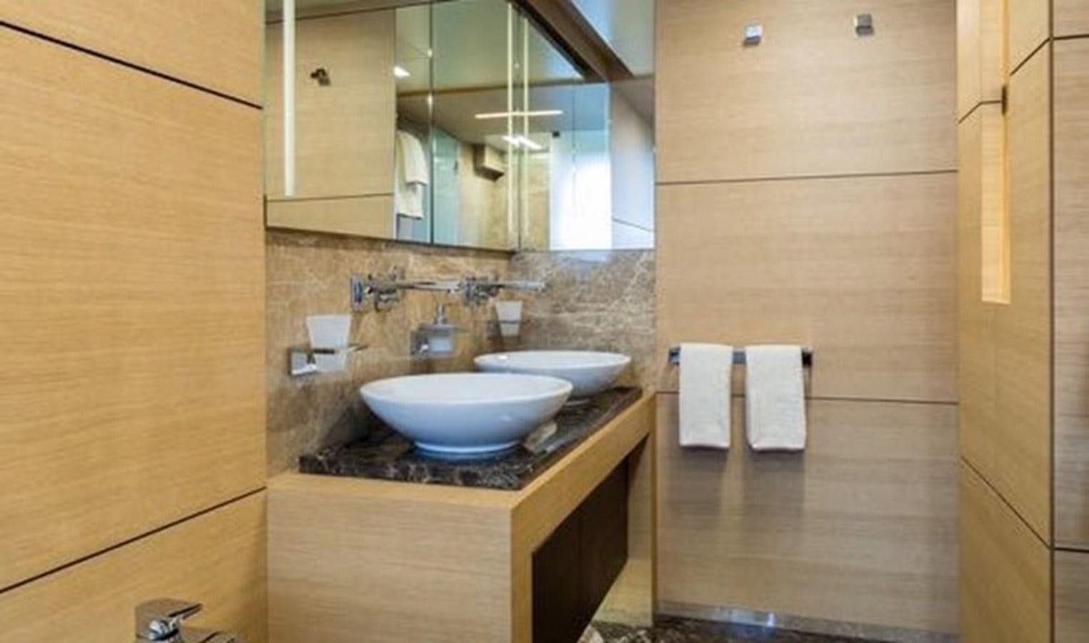 a bathroom with a sink and a mirror aboard BENETTI 132 Yacht for Sale