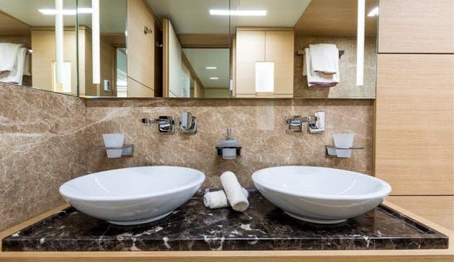 a bathroom with sinks and mirrors aboard BENETTI 132 Yacht for Sale