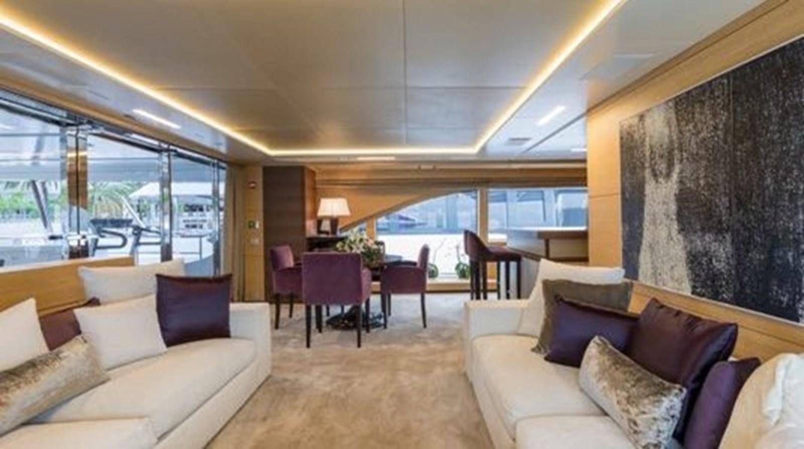 a living room with a large window aboard BENETTI 132 Yacht for Sale