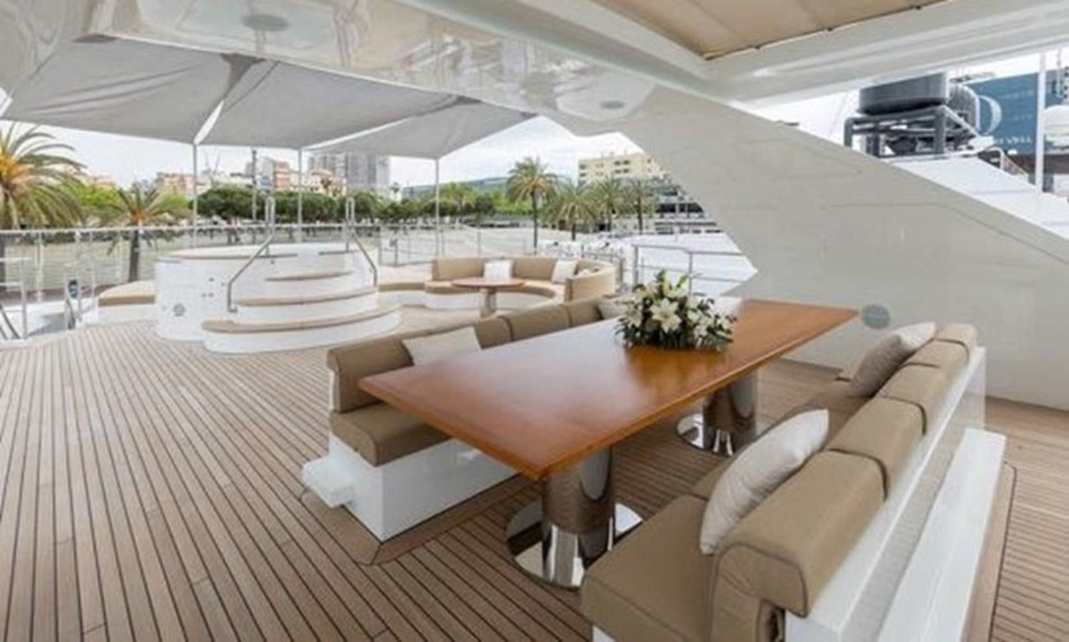 a room with a table and chairs aboard BENETTI 132 Yacht for Sale