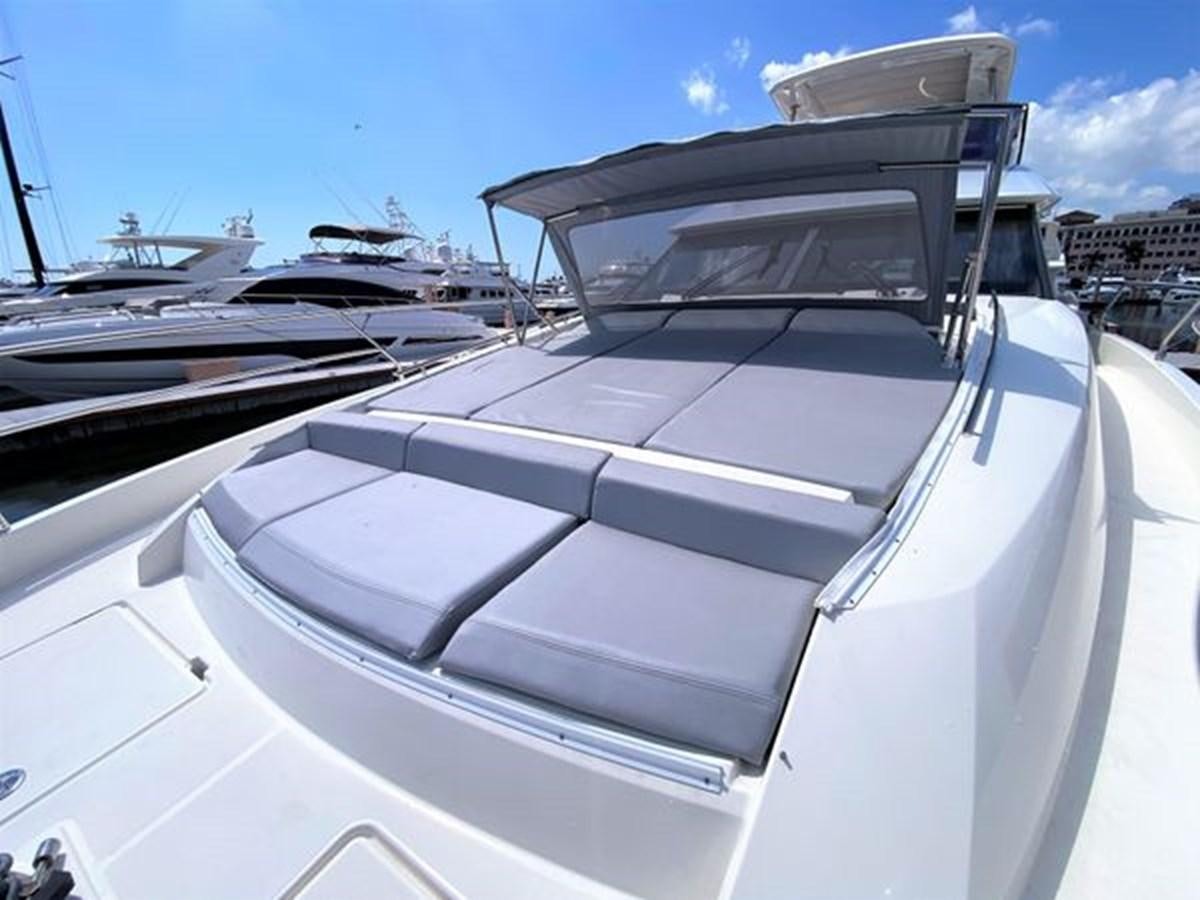 a white yacht with a large boat in the background aboard 2016 PRESTIGE 680 FLY Yacht for Sale