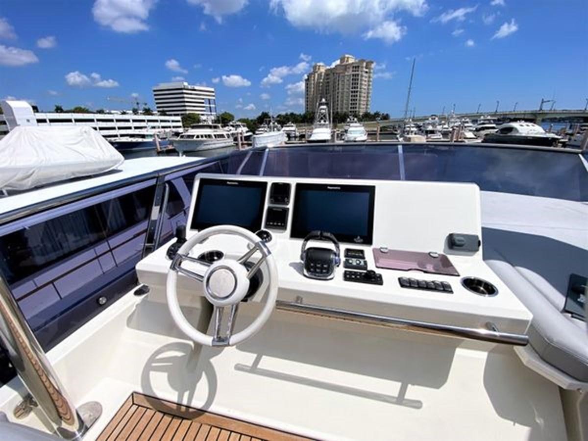 a white yacht in a harbor aboard 2016 PRESTIGE 680 FLY Yacht for Sale
