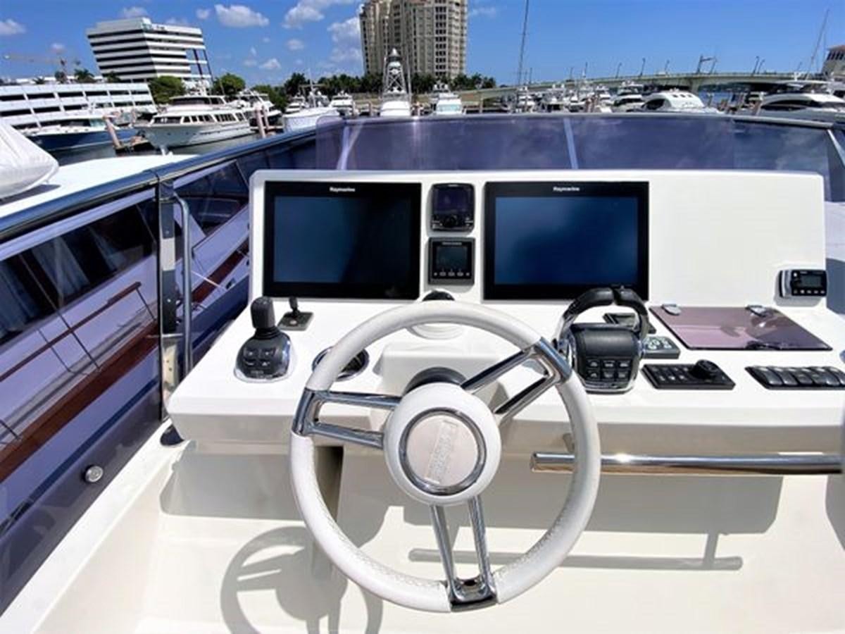 a white boat with a steering wheel aboard 2016 PRESTIGE 680 FLY Yacht for Sale