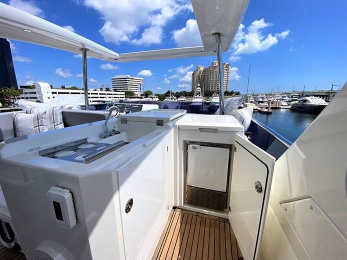 a boat with a sink and a large building in the background aboard 2016 PRESTIGE 680 FLY Yacht for Sale