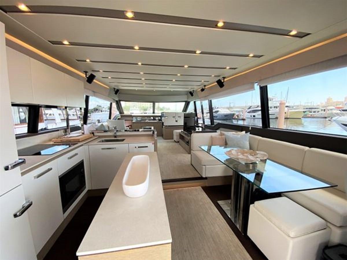 a room with a table and chairs aboard 2016 PRESTIGE 680 FLY Yacht for Sale