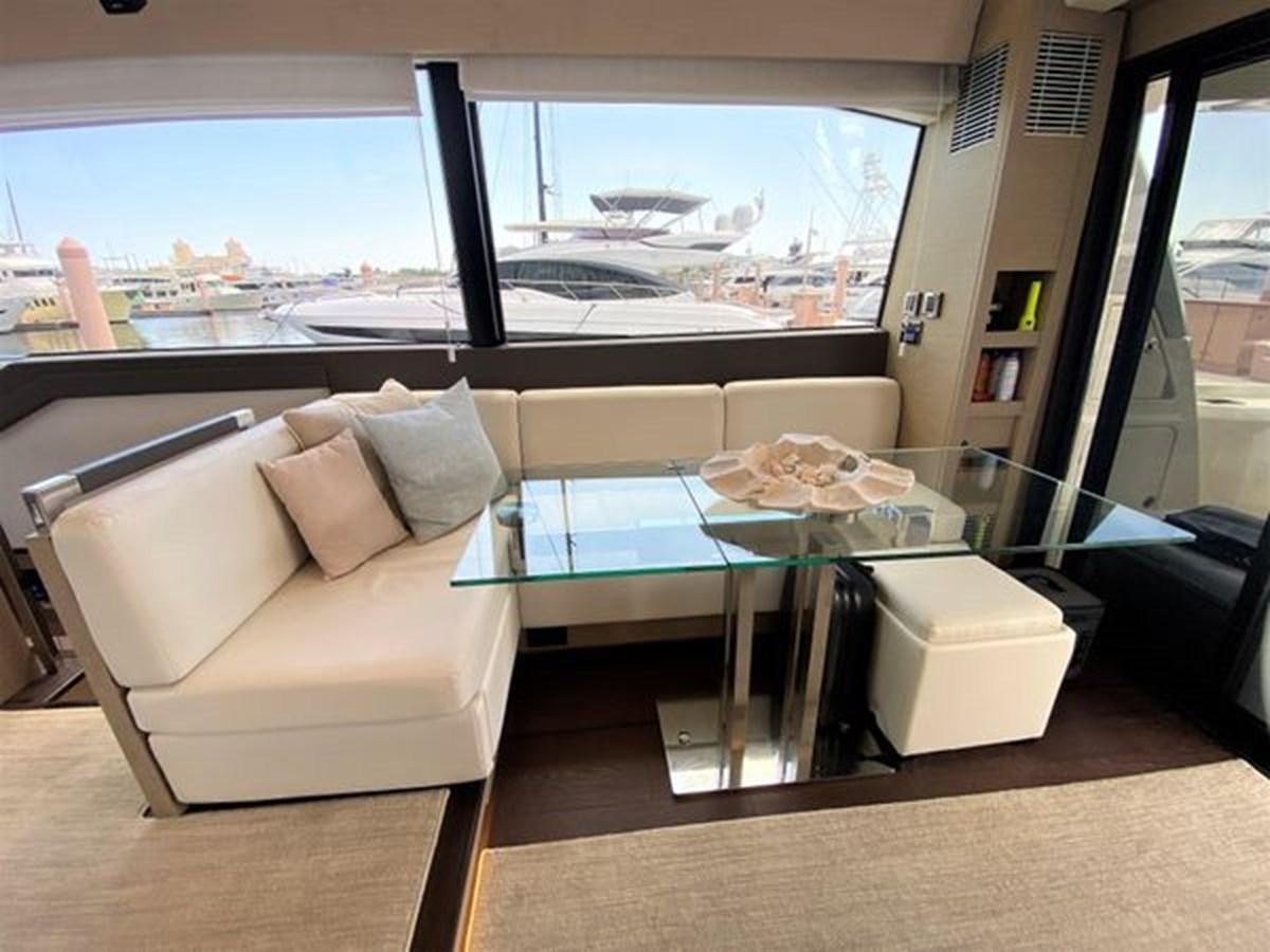 a living room with a large window aboard 2016 PRESTIGE 680 FLY Yacht for Sale