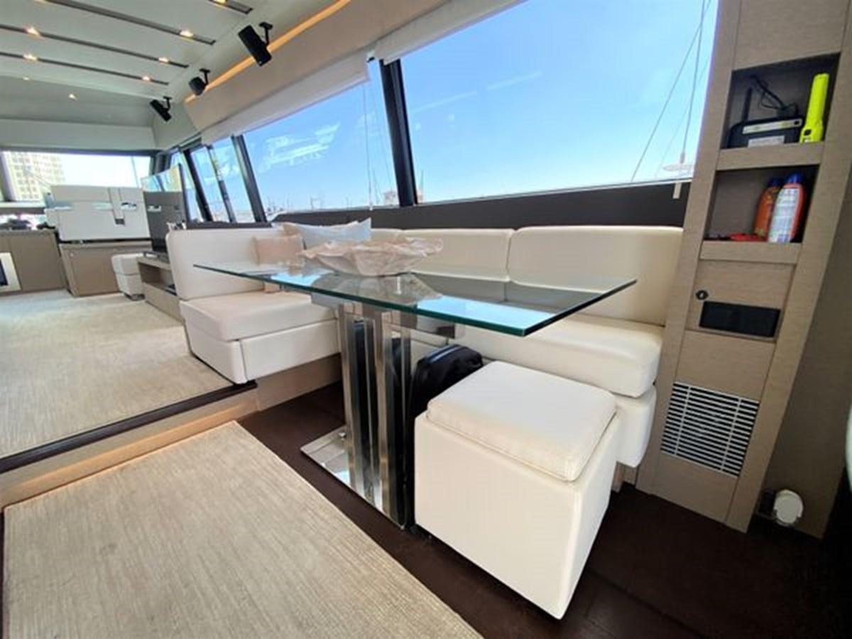 a living room with a glass table aboard 2016 PRESTIGE 680 FLY Yacht for Sale