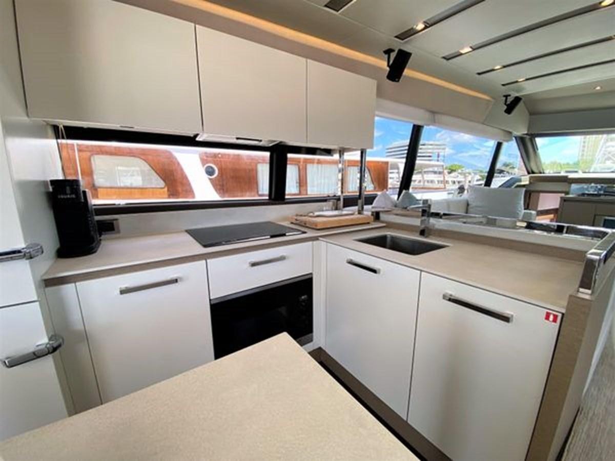 a kitchen with white cabinets aboard 2016 PRESTIGE 680 FLY Yacht for Sale