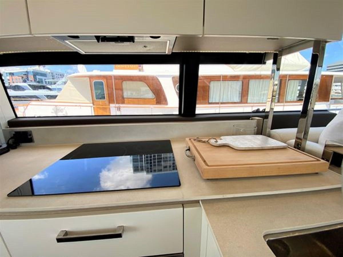 a room with a table and a window aboard 2016 PRESTIGE 680 FLY Yacht for Sale