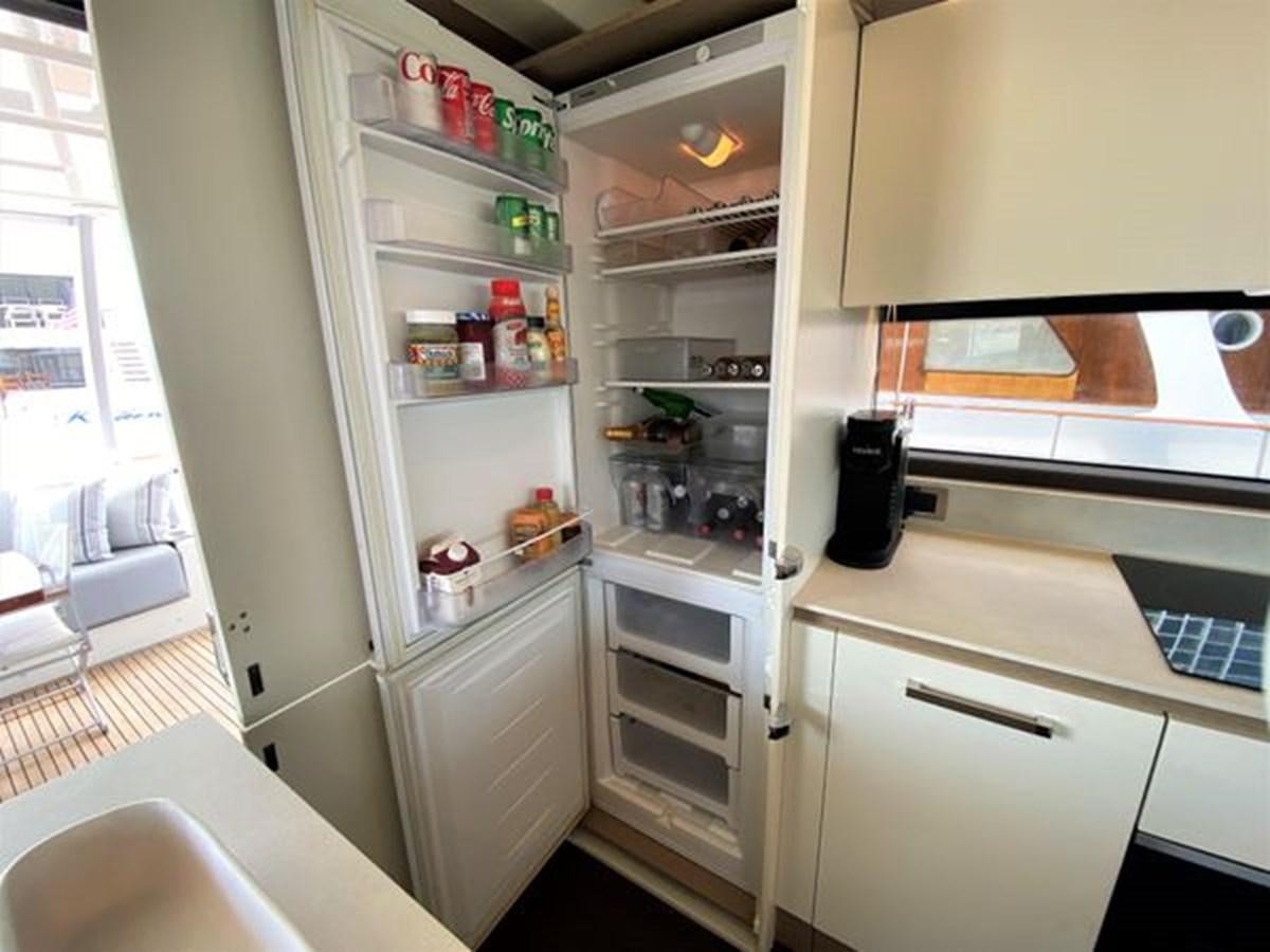 a kitchen with a refrigerator aboard 2016 PRESTIGE 680 FLY Yacht for Sale